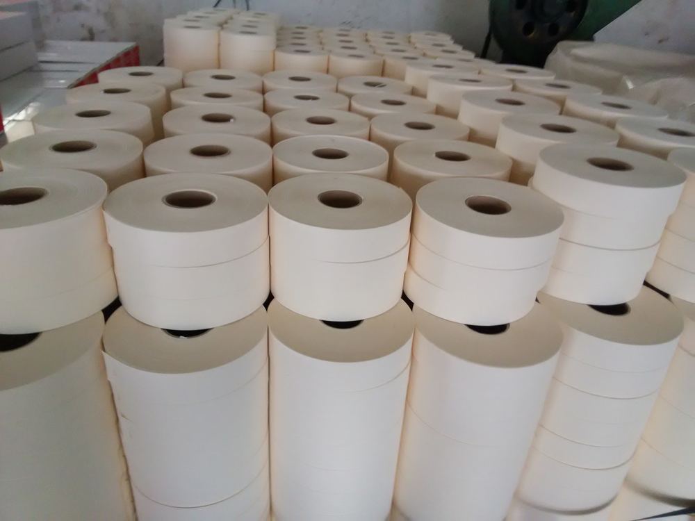 Rolls of drywall joint paper tape packed in bulk cartons